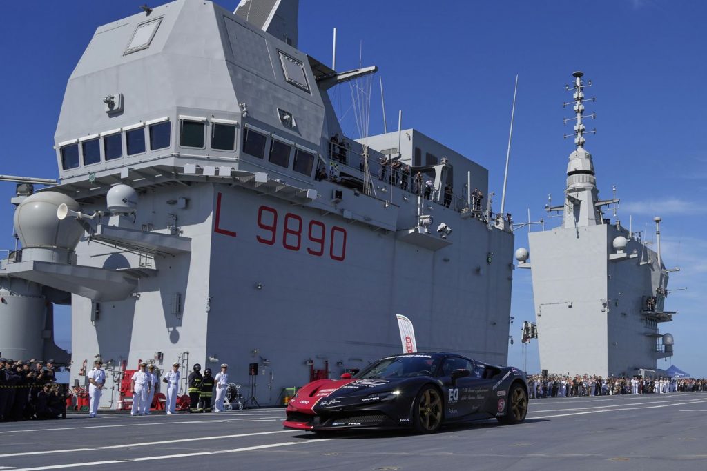 One man in an Italian supercar atop an plane service. And a file in his sights