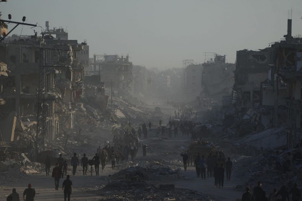 A ceasefire holds, U.S. troops land in Israel and Palestinians return to ruins